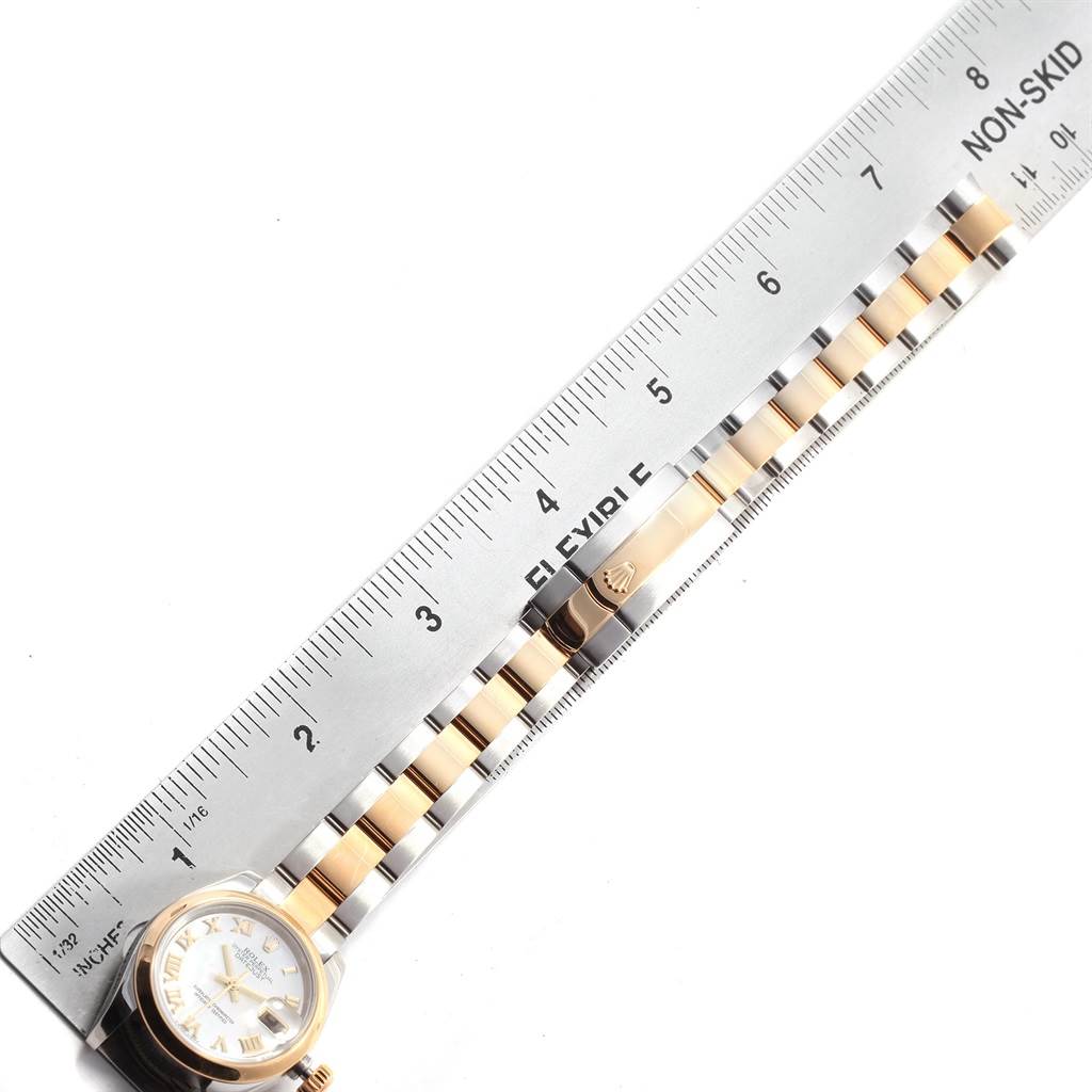 The image shows a Rolex Datejust 179163 Women's Steel and Gold (two tone) Mother of Pearl Dial 179163 Women's Steel and Gold (two tone) Mother of Pearl Dial watch laying flat with a ruler beside it, highlighting its bracelet and dial.