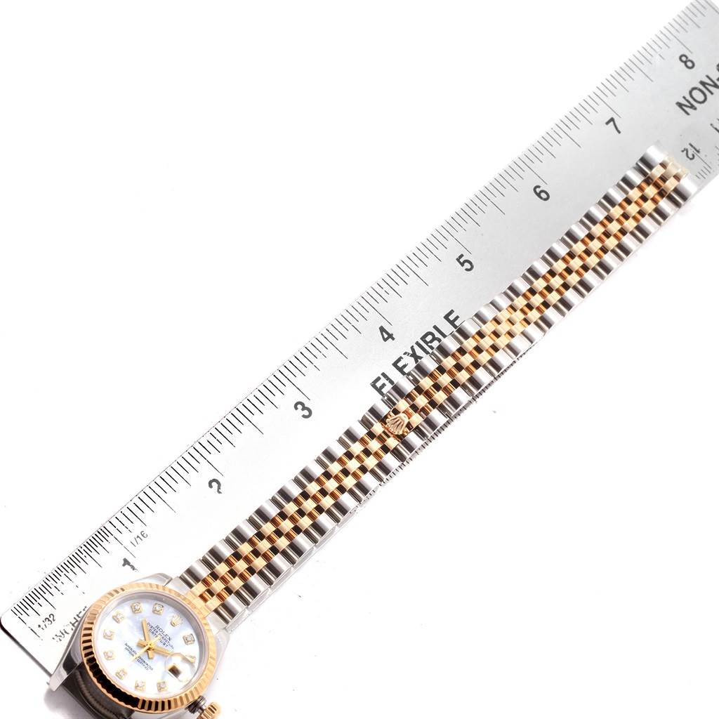 The image shows the band and part of the dial of a Rolex Datejust 179173 Women's Steel and Gold (two tone) Mother of Pearl Dial 179173 Women's Steel and Gold (two tone) Mother of Pearl Dial watch next to a ruler for scale.