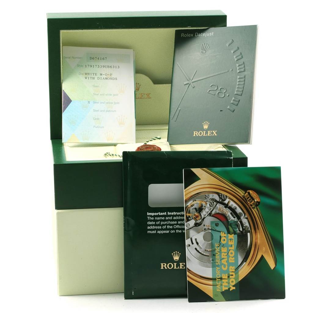 The image shows accessories for a Rolex Datejust 179173 Women's Steel and Gold (two tone) Mother of Pearl Dial 179173 Women's Steel and Gold (two tone) Mother of Pearl Dial, including booklets, warranty card, and a watch box.