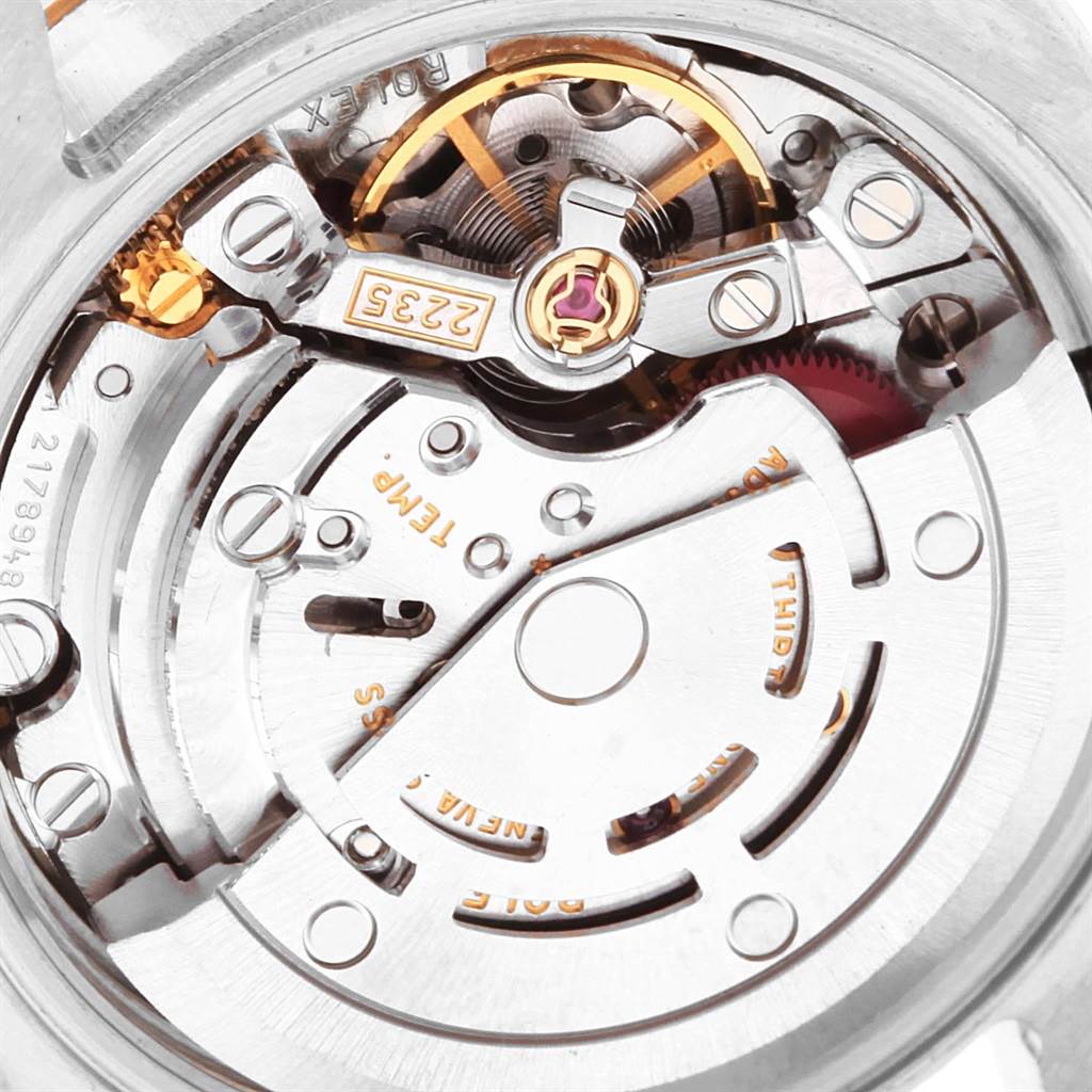 This image shows a close-up view of the Datejust model by Rolex, highlighting its intricate movement and inner mechanisms.
