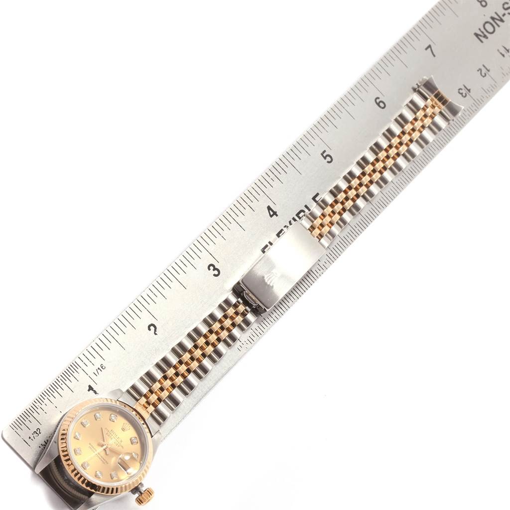 The image shows a Rolex Datejust 69173 Women's Stainless Steel Champagne Dial 69173 Women's Stainless Steel Champagne Dial watch face and part of the bracelet, aligned next to a ruler for measurement.