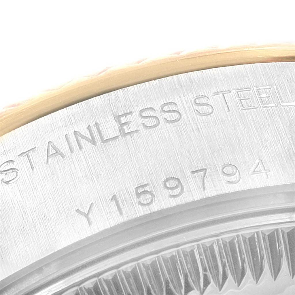 The image shows a close-up of a stainless steel part of a Rolex Datejust 69173 Women's Stainless Steel Champagne Dial 69173 Women's Stainless Steel Champagne Dial watch with serial number engraving visible.