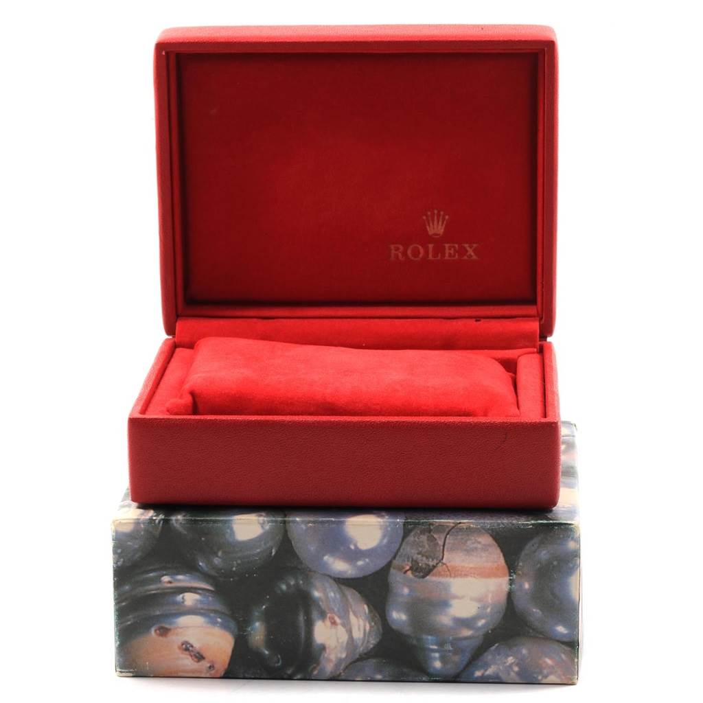 This image shows an open, red Rolex box for the Datejust model, displaying its interior and cushion.