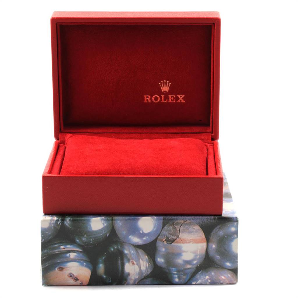 The image shows an open red Rolex Datejust 79173 Women's Steel and Gold (two tone) White Dial 79173 Women's Steel and Gold (two tone) White Dial watch box with a red cushion inside, placed on a decorative base.
