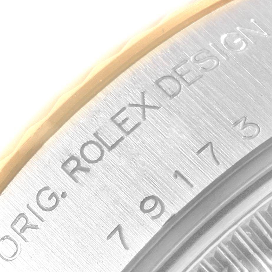 The close-up image shows the engraved edge of a Rolex Datejust 79173 Women's Steel and Gold (two tone) White Dial 79173 Women's Steel and Gold (two tone) White Dial watch case.