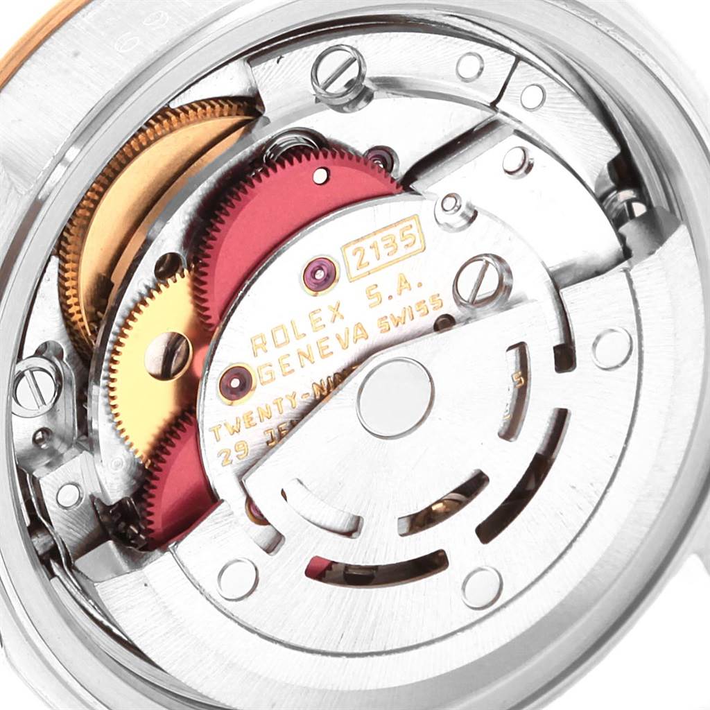 The image shows a close-up view of the Rolex Datejust 69173 Women's Stainless Steel Blue Dial 69173 Women's Stainless Steel Blue Dial movement mechanism, highlighting its gears and internal components.