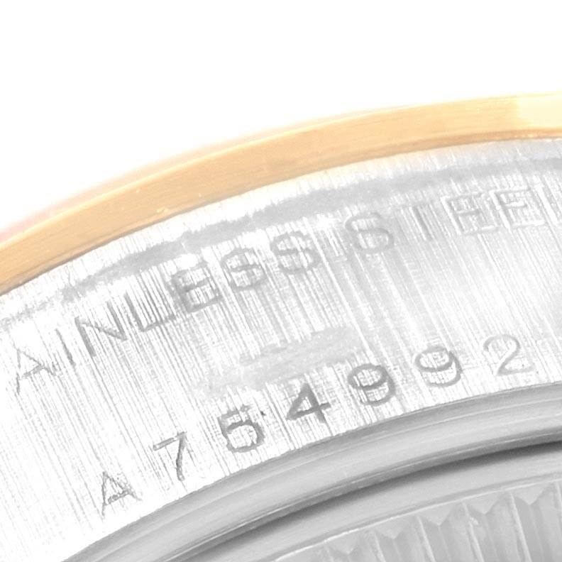 The image shows a close-up angle of the serial number and "STAINLESS STEEL" engraving on a Rolex Datejust 79163 Women's Steel and Gold (two tone) Silver Dial 79163 Women's Steel and Gold (two tone) Silver Dial watch.