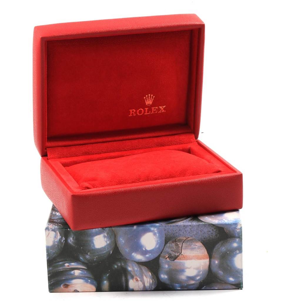 This image shows a red Rolex Datejust 79173 Women's Steel and Gold (two tone) Beige Dial 79173 Women's Steel and Gold (two tone) Beige Dial watch box open, displaying its interior.