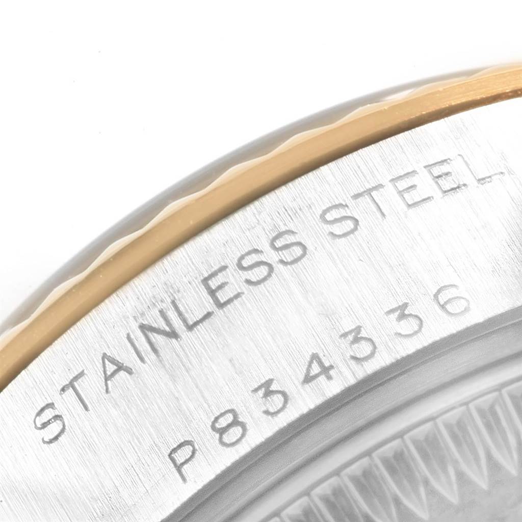 This close-up image shows the engraved stainless steel casing and serial number of a Rolex Datejust 79173 Women's Steel and Gold (two tone) Beige Dial 79173 Women's Steel and Gold (two tone) Beige Dial watch.