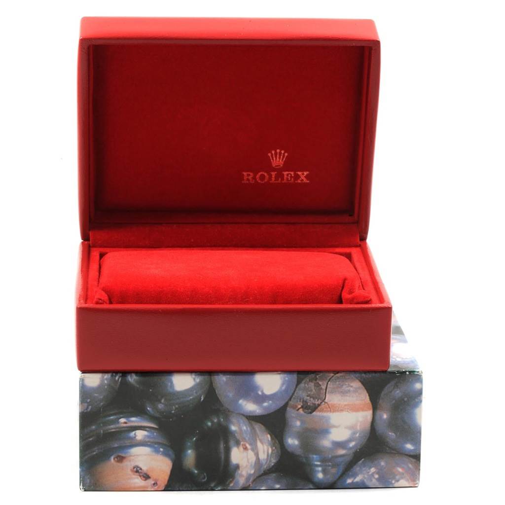 The image displays an open red Rolex watch box, likely for a Datejust model, with a cushioned interior.