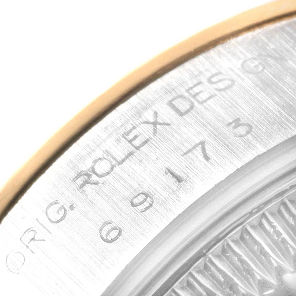 The image shows a close-up of the engraved outer rim of a Rolex Datejust 69173 Women's Stainless Steel White Dial 69173 Women's Stainless Steel White Dial watch case, featuring the brand name and design number.