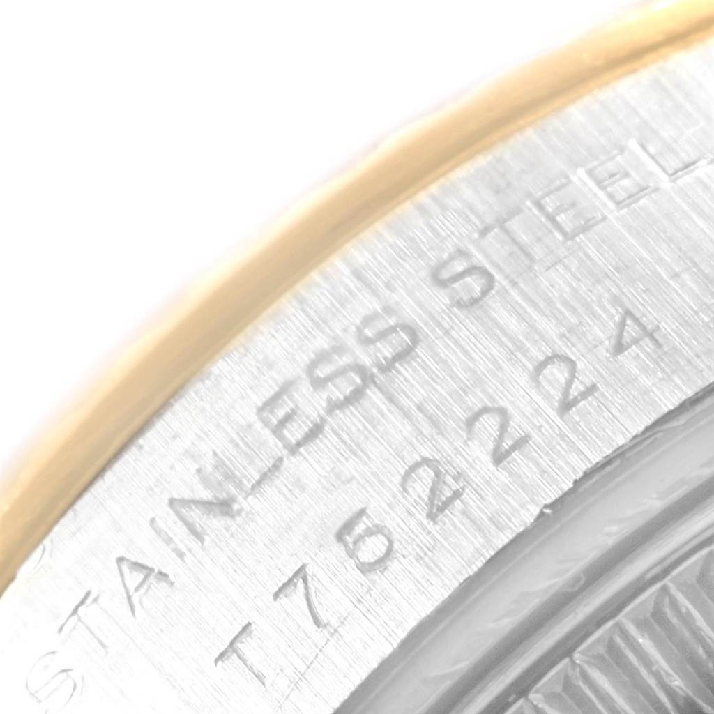 This image shows a close-up of the engravings on the side of a Rolex Datejust 69173 Women's Stainless Steel White Dial 69173 Women's Stainless Steel White Dial watch, featuring "STAINLESS STEEL" and a serial/part number.