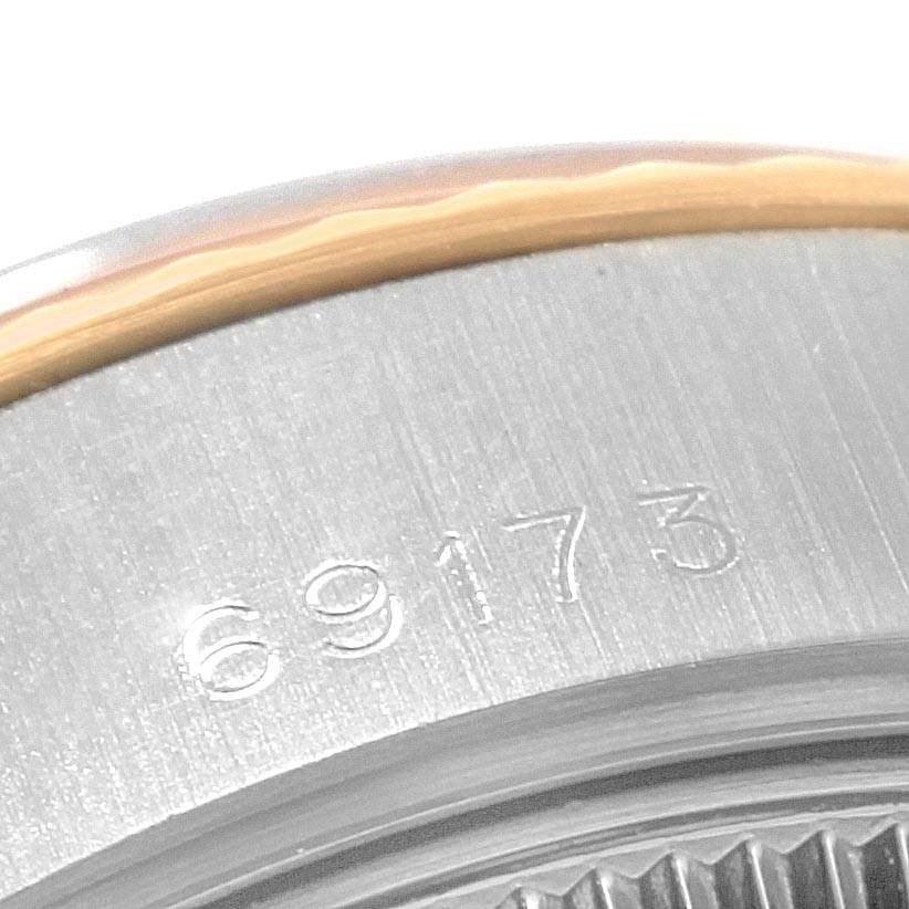This close-up angle of a Rolex Datejust 69173 Women's Stainless Steel Black Dial 69173 Women's Stainless Steel Black Dial watch shows the model number "69173" engraved on its caseback.