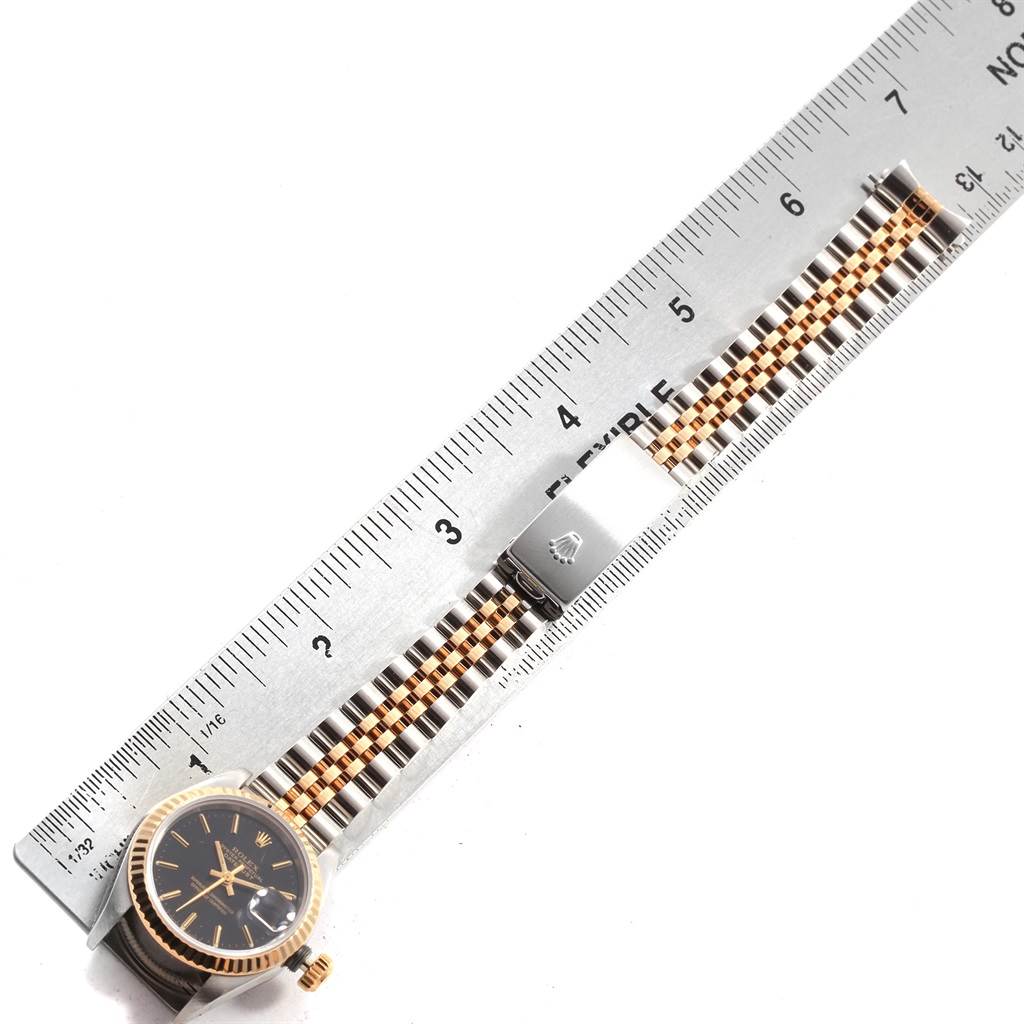 The image shows a Rolex Datejust 69173 Women's Stainless Steel Black Dial 69173 Women's Stainless Steel Black Dial watch lying flat with its bracelet placed adjacent to a ruler for measurement.