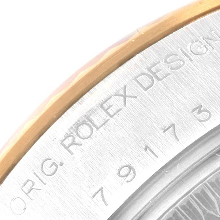 Close-up of the edge and engraving on the case back of a Rolex Datejust 79173 Women
s Stainless Steel Black Dial 79173 Women
s Stainless Steel Black Dial watch, showing "ORIG. ROLEX DESIGN 79173".