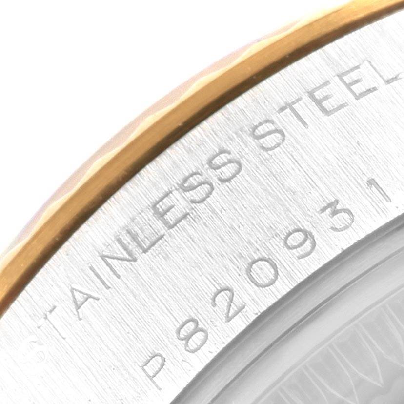 This close-up image of the Rolex Datejust 79173 Women
s Stainless Steel Black Dial 79173 Women
s Stainless Steel Black Dial watch shows the stainless steel case back and part of the gold bezel.