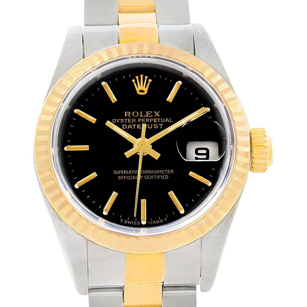 This image shows a frontal view of a Rolex Datejust 79173 Women
s Stainless Steel Black Dial 79173 Women
s Stainless Steel Black Dial watch, displaying the black dial, date window, gold bezel, and part of the bracelet.