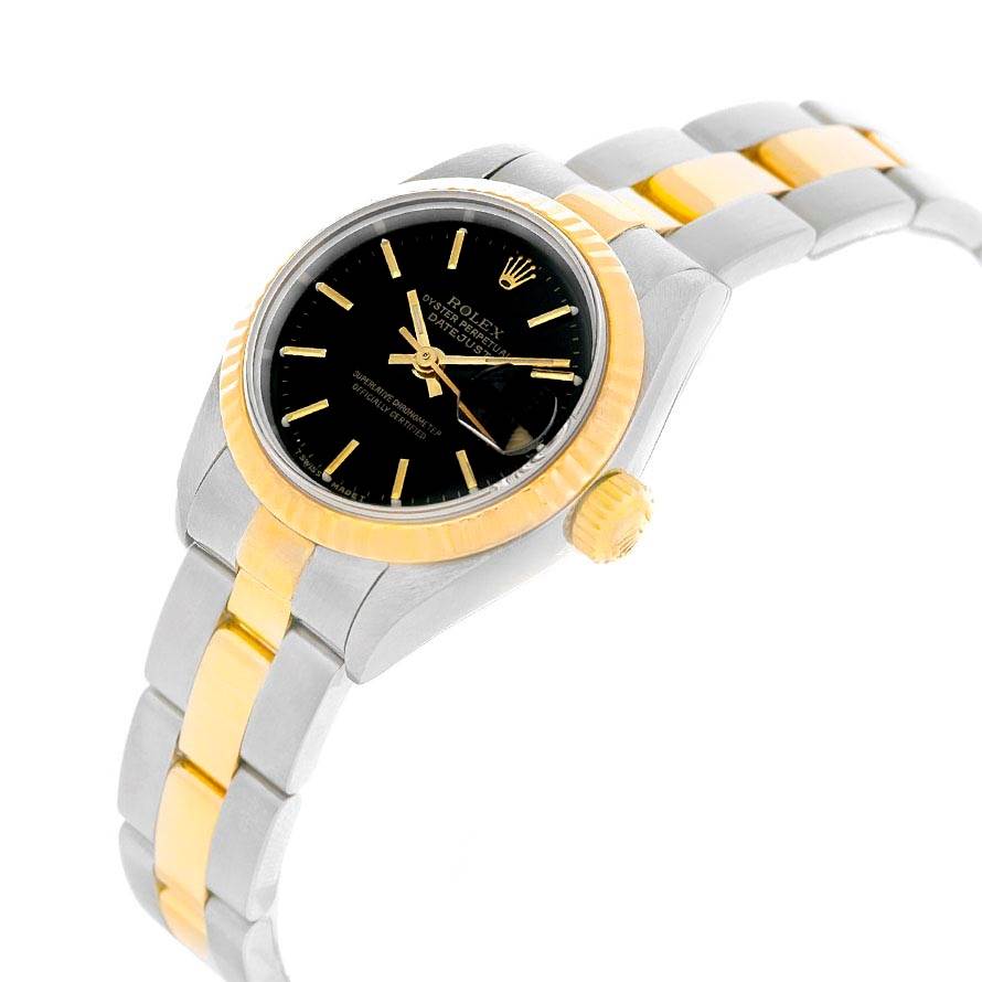 The image shows a Rolex Datejust 79173 Women
s Stainless Steel Black Dial 79173 Women
s Stainless Steel Black Dial watch at a slight angle, featuring its black dial, fluted bezel, and two-tone bracelet.