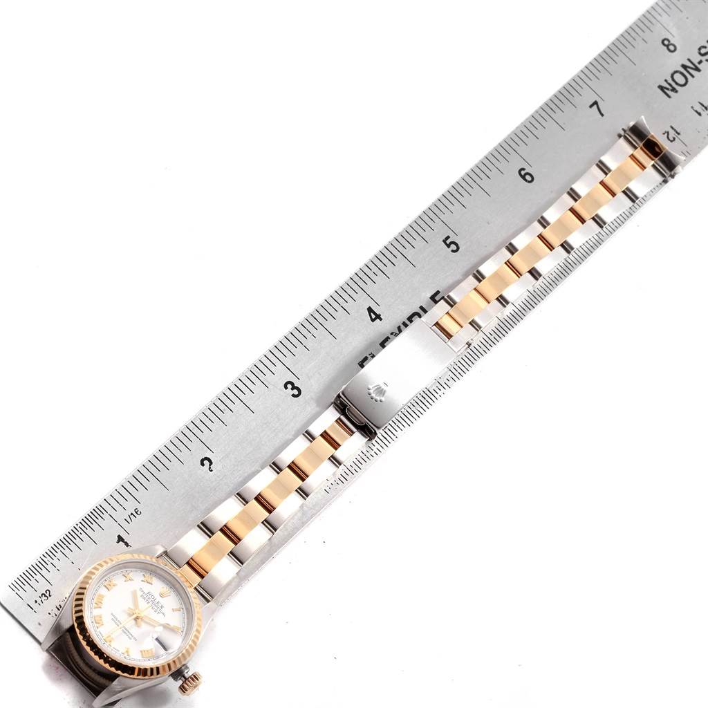 This image shows a Rolex Datejust 79173 Women's Steel and Gold (two tone) White Dial 79173 Women's Steel and Gold (two tone) White Dial watch laid flat with a ruler measuring its bracelet length.