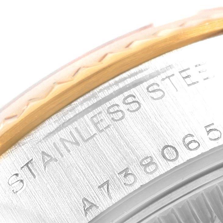 This close-up image of a Rolex Datejust 79173 Women's Steel and Gold (two tone) White Dial 79173 Women's Steel and Gold (two tone) White Dial watch shows the edge of the bezel and the engraved stainless steel case with the serial number.