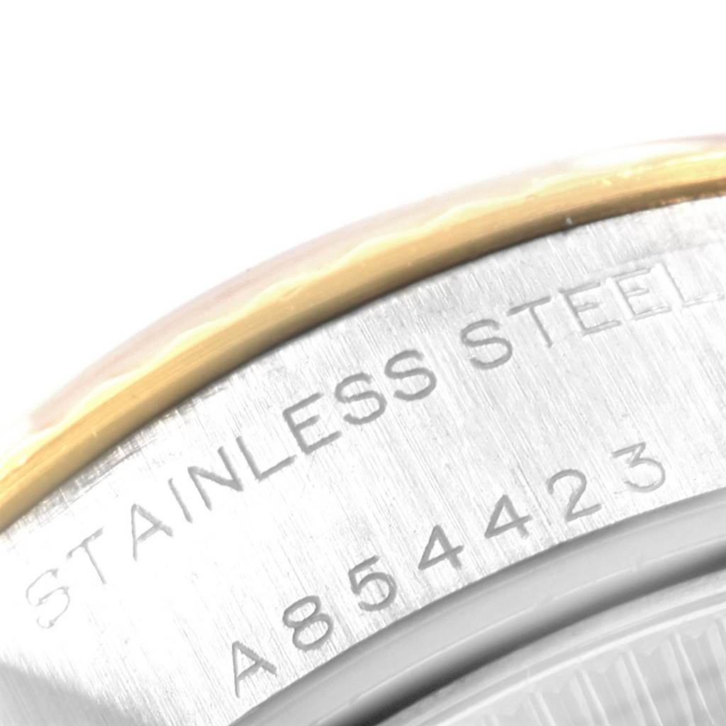 This close-up image shows the case back of a Rolex Datejust 79173 Women's Steel and Gold (two tone) Beige Dial 79173 Women's Steel and Gold (two tone) Beige Dial watch, highlighting the stainless steel inscription and serial number.