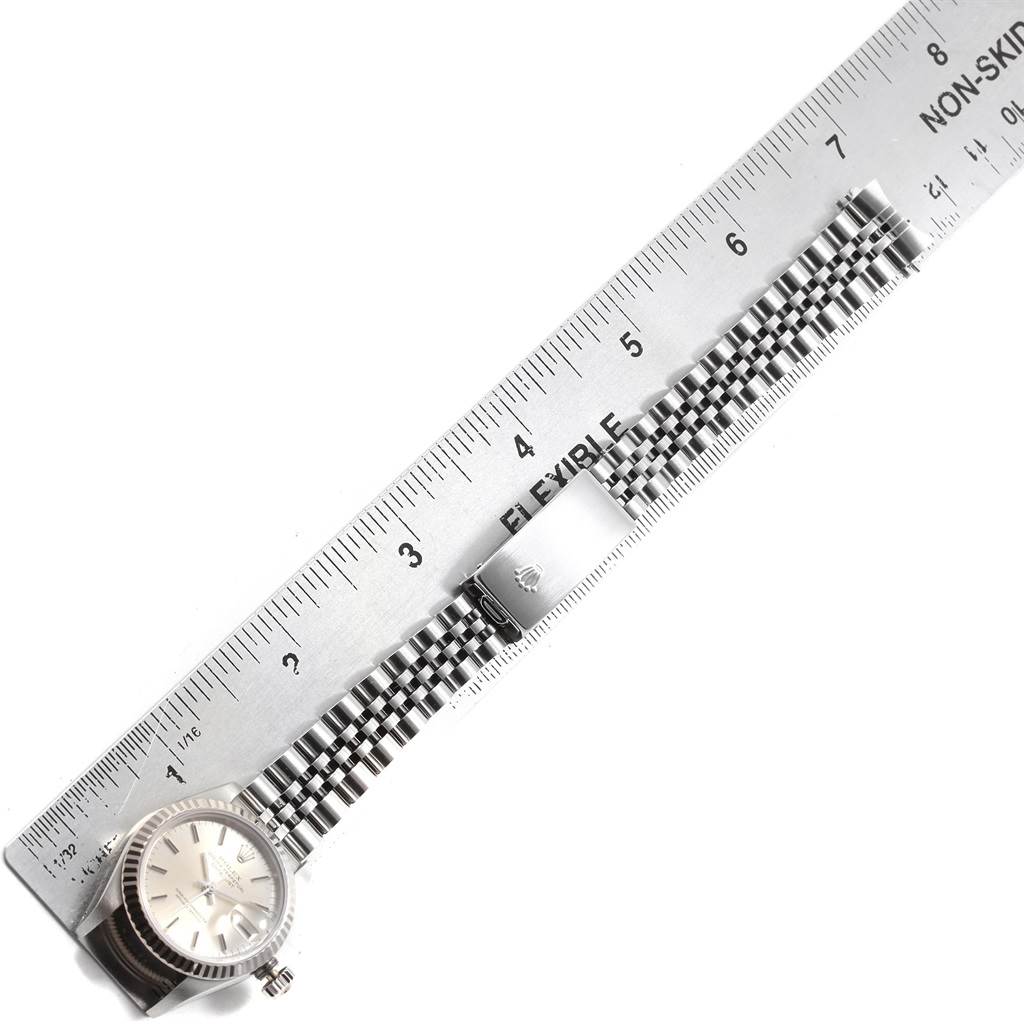 The image shows a Rolex Datejust 69174 Women's Stainless Steel Silver Dial 69174 Women's Stainless Steel Silver Dial watch shot from above, with emphasis on its face, bracelet, and clasp alongside a ruler for scale.