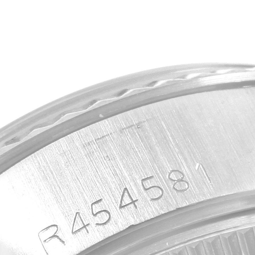 This is a close-up of the case side of a Rolex Datejust 69174 Women's Stainless Steel Silver Dial 69174 Women's Stainless Steel Silver Dial watch, showing the serial number engraving.