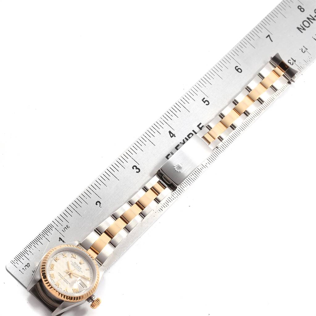 The image shows a Rolex Datejust 79173 Women's Steel and Gold (two tone) Beige Dial 79173 Women's Steel and Gold (two tone) Beige Dial watch, laid flat with both the face and the bracelet visible next to a measuring ruler.