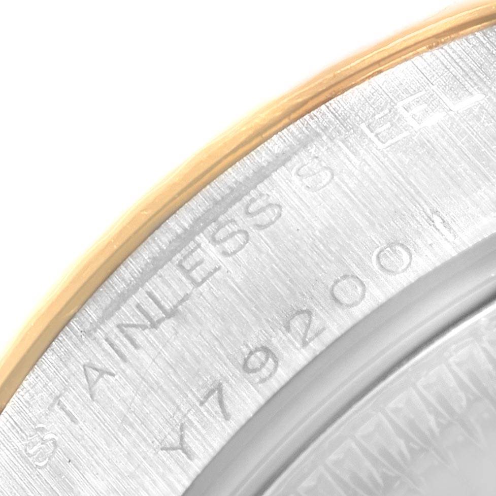 This image shows a close-up of the stainless steel case back and the bezel of a Rolex Datejust 79173 Women's Steel and Gold (two tone) Beige Dial 79173 Women's Steel and Gold (two tone) Beige Dial watch.