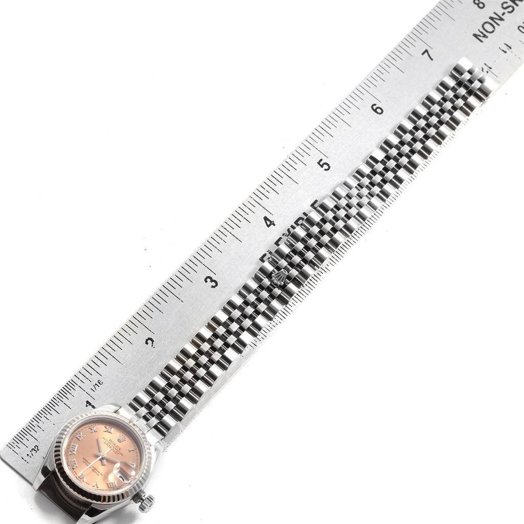 The image shows the face and bracelet of a Rolex Datejust 179174 Women
s Stainless Steel Pink Dial 179174 Women
s Stainless Steel Pink Dial watch, measured alongside a ruler.