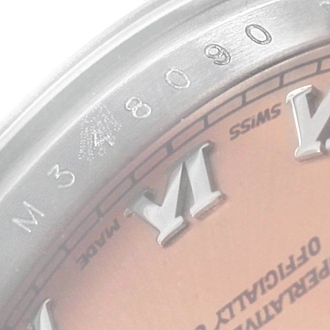This close-up shows part of the bezel, dial, and Roman numeral markers of a Rolex Datejust 179174 Women
s Stainless Steel Pink Dial 179174 Women
s Stainless Steel Pink Dial watch.