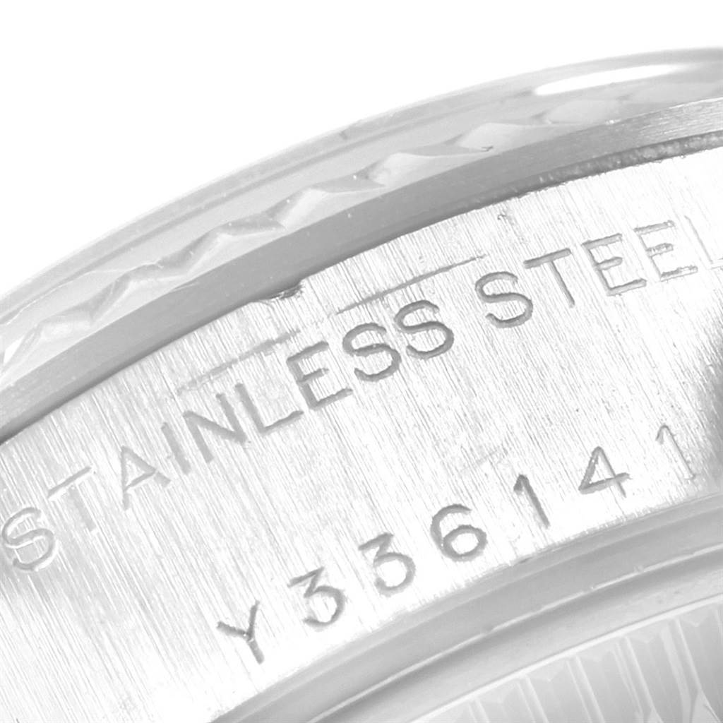 This close-up image shows the engraved serial number and "STAINLESS STEEL" text on the case back edge of a Rolex Datejust 79174 Women's Stainless Steel Silver Dial 79174 Women's Stainless Steel Silver Dial watch.