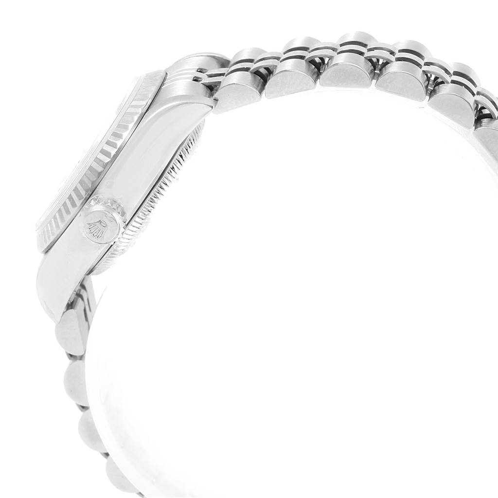 This side view of the Rolex Datejust 79174 Women's Stainless Steel Silver Dial 79174 Women's Stainless Steel Silver Dial watch shows the crown, case, and part of the bracelet.