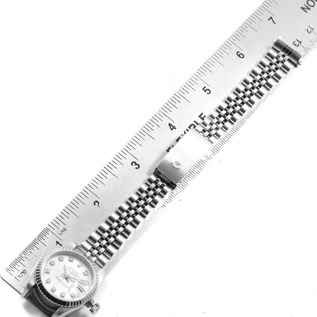 The image shows a top view of a Rolex Datejust 79174 Women's Stainless Steel Silver Dial 79174 Women's Stainless Steel Silver Dial model, displaying the face and Jubilee bracelet against a ruler for scale.