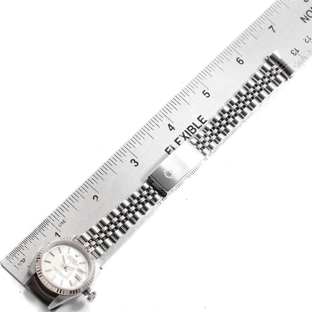 The Rolex Datejust 69174 Women's Stainless Steel Silver Dial 69174 Women's Stainless Steel Silver Dial watch is shown lying flat, with its face (dial) and metal bracelet fully visible under a ruler for measurement.