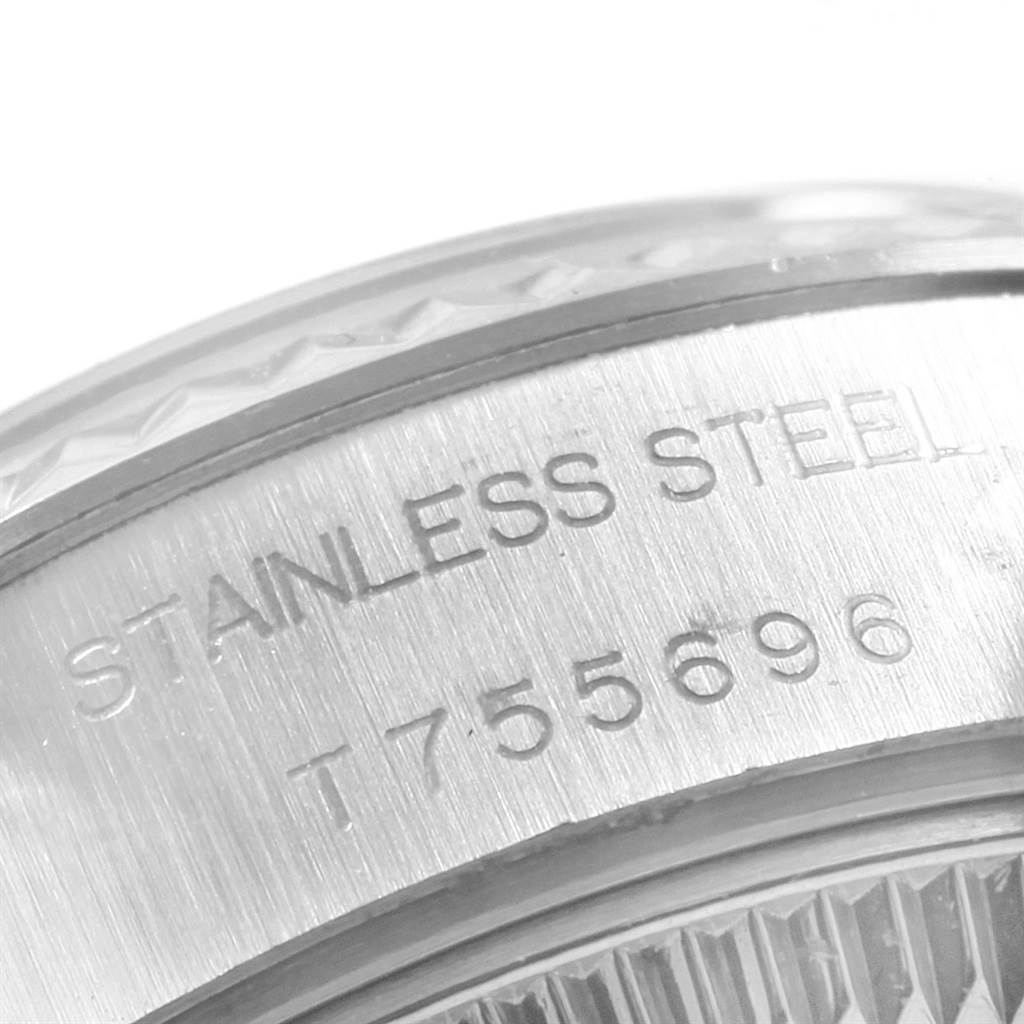 This close-up image shows the engraved text on the stainless steel case of a Rolex Datejust 69174 Women's Stainless Steel Silver Dial 69174 Women's Stainless Steel Silver Dial watch.