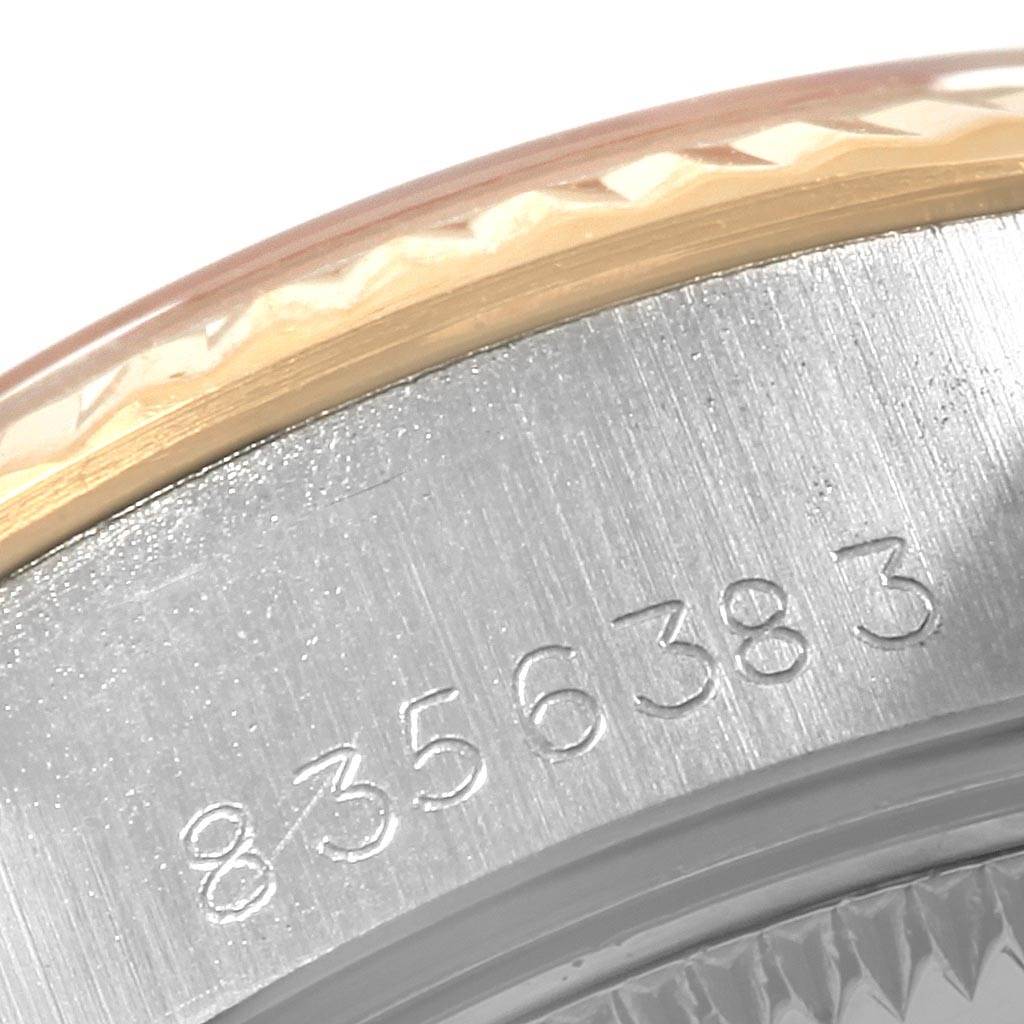 The image shows a close-up of the serial number engraving on the side of the bezel and case of a Rolex Datejust 69173 Women's Stainless Steel White Dial 69173 Women's Stainless Steel White Dial watch.