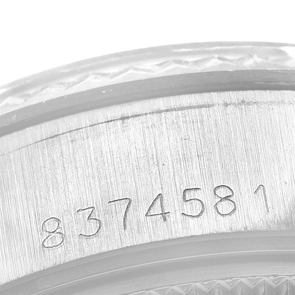 The image shows a close-up of the serial number engraved on the case of a Rolex Datejust 69174 Women's Stainless Steel Silver Dial 69174 Women's Stainless Steel Silver Dial watch.