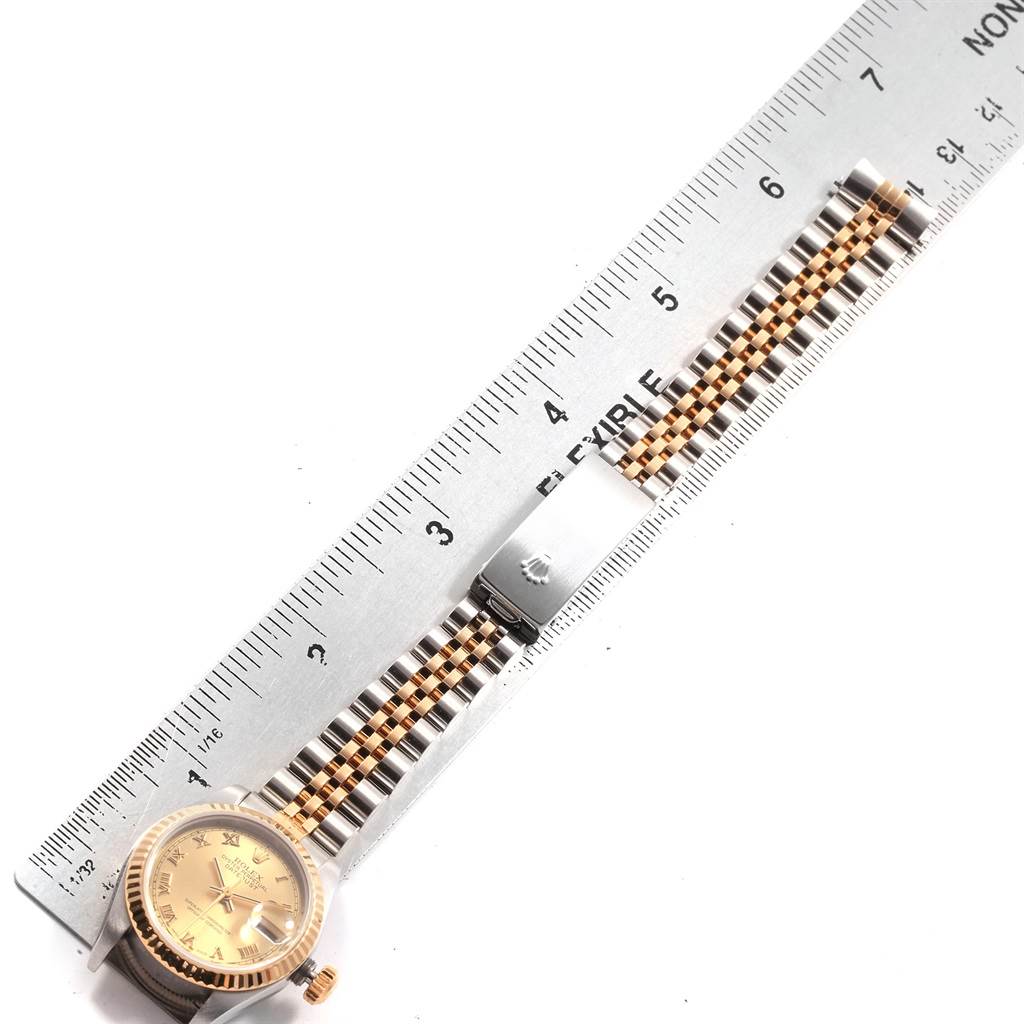 This image shows a Datejust Rolex watch with its face, bracelet, and clasp aligned beside a ruler.