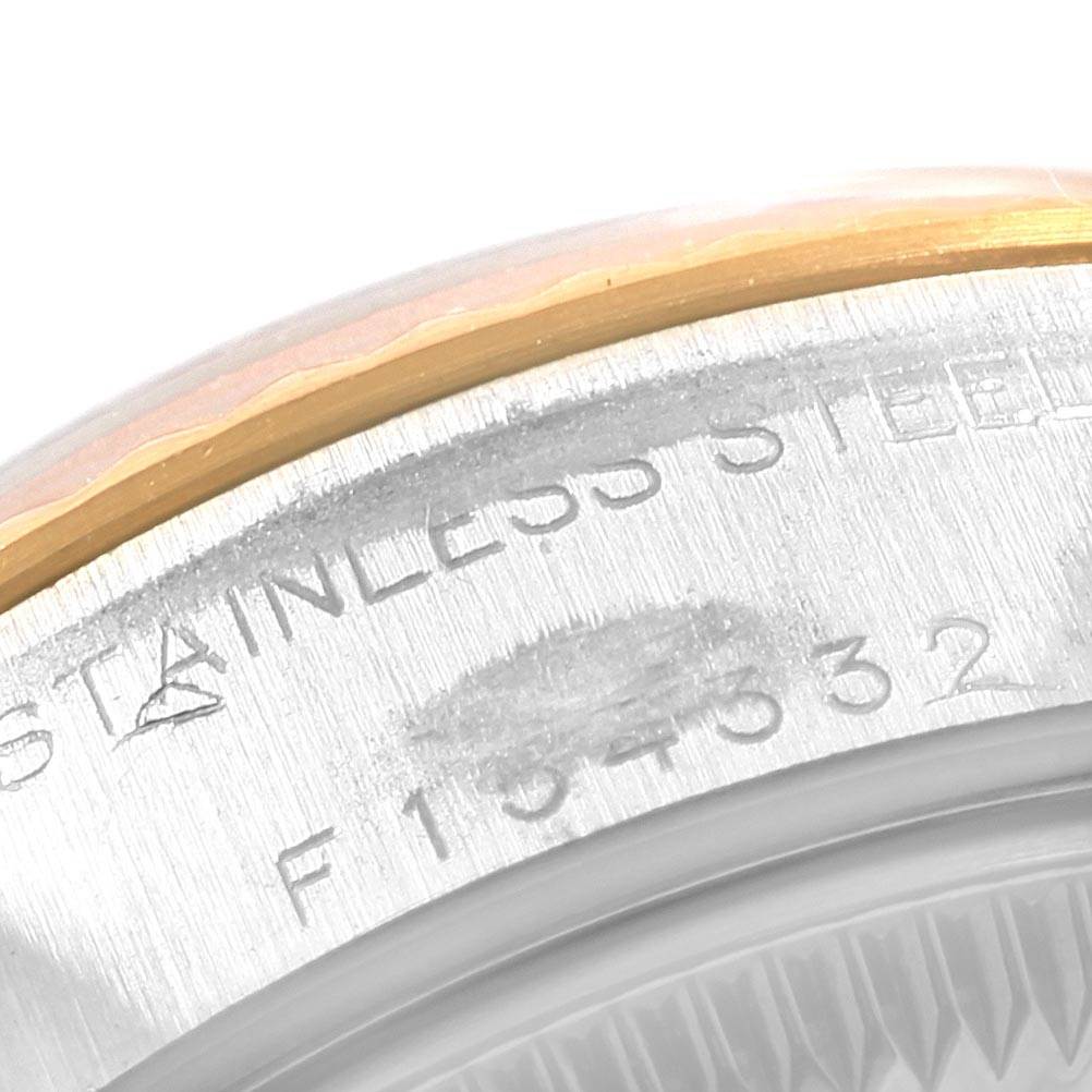 This close-up image shows the serial number engraving and part of the bezel on a Rolex Datejust 79173 Women's Steel and Gold (two tone) Silver Dial 79173 Women's Steel and Gold (two tone) Silver Dial watch.