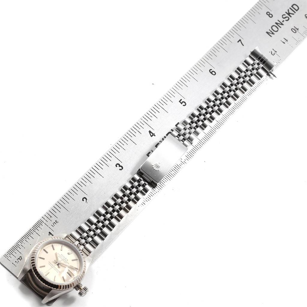 The image shows a Rolex Datejust 69174 Women's Stainless Steel Silver Dial 69174 Women's Stainless Steel Silver Dial watch laid flat, positioned beside a ruler, highlighting the watch face and the metal bracelet band.