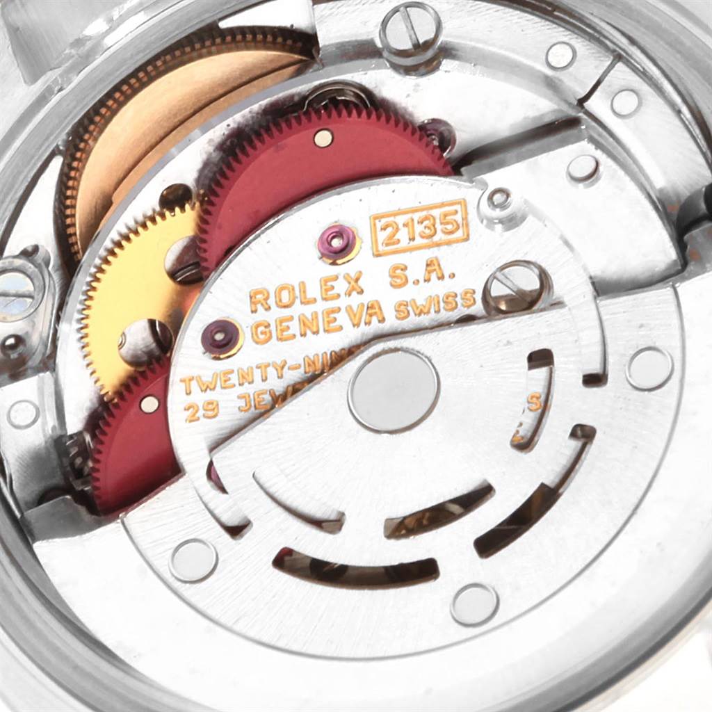 The image shows the internal mechanism of a Rolex Datejust 19784 Women's Stainless Steel White Dial 19784 Women's Stainless Steel White Dial watch, featuring gears and the movement components.