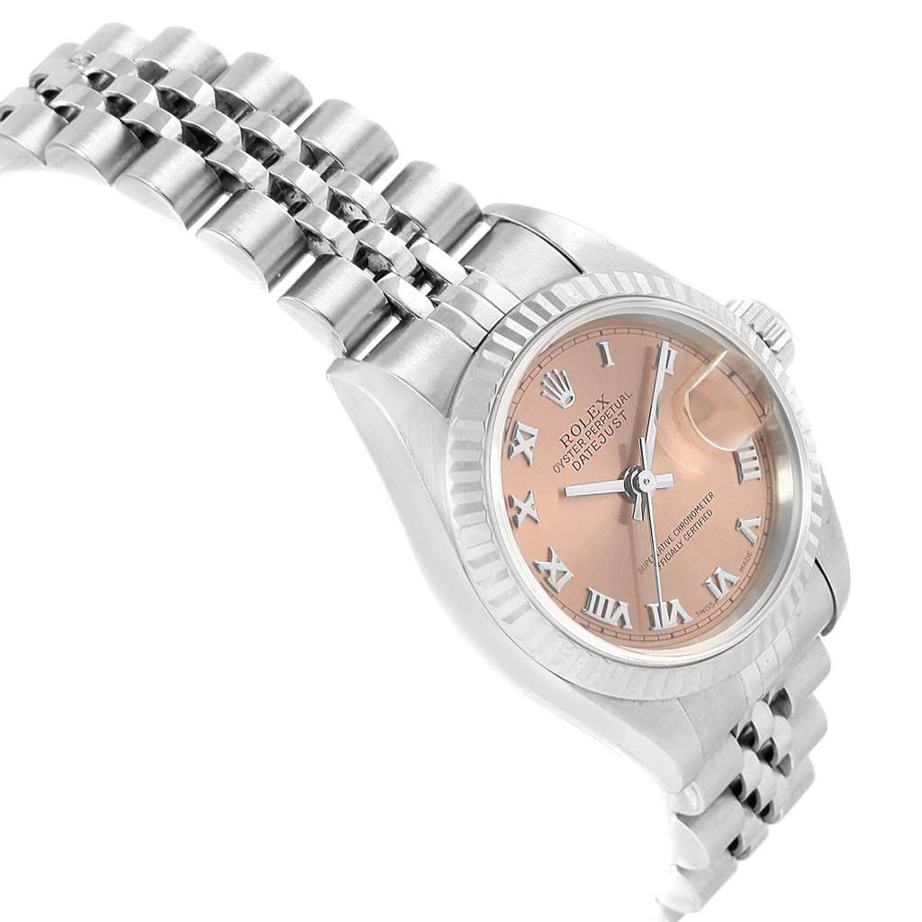 The Rolex Datejust 79174 Women
s Stainless Steel Pink Dial 79174 Women
s Stainless Steel Pink Dial watch is shown at a slight side angle, displaying the pink dial, Roman numerals, and part of the Jubilee bracelet.
