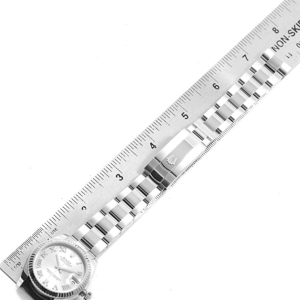 The image shows a Rolex Datejust 178274 Women's Stainless Steel Silver Dial 178274 Women's Stainless Steel Silver Dial watch laid flat, with a focus on its bracelet and clasp, alongside a ruler for scale.