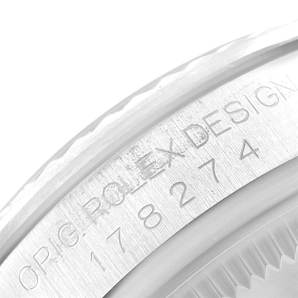 This close-up image shows the engraved serial number and Rolex branding on the side of a Rolex Datejust 178274 Women's Stainless Steel Silver Dial 178274 Women's Stainless Steel Silver Dial watch case.