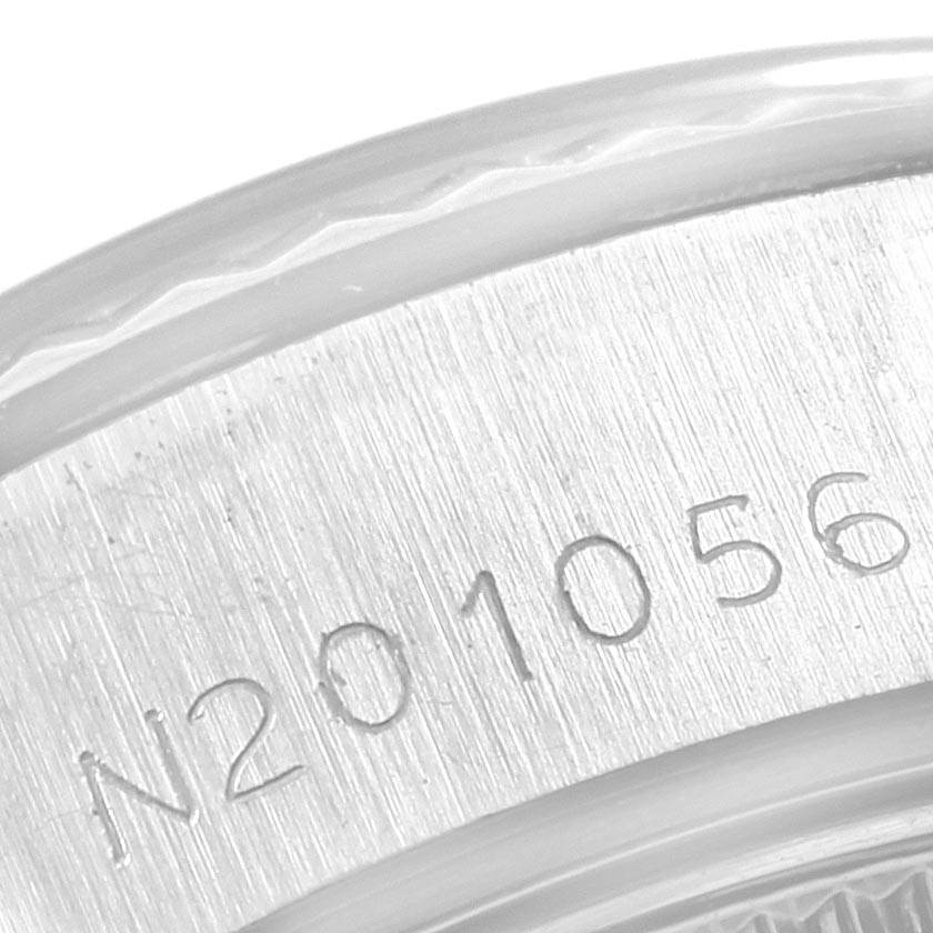 The image shows a close-up of the engraved serial number on the side of a Rolex Datejust 69174 Women's Stainless Steel Silver Dial 69174 Women's Stainless Steel Silver Dial watch case.