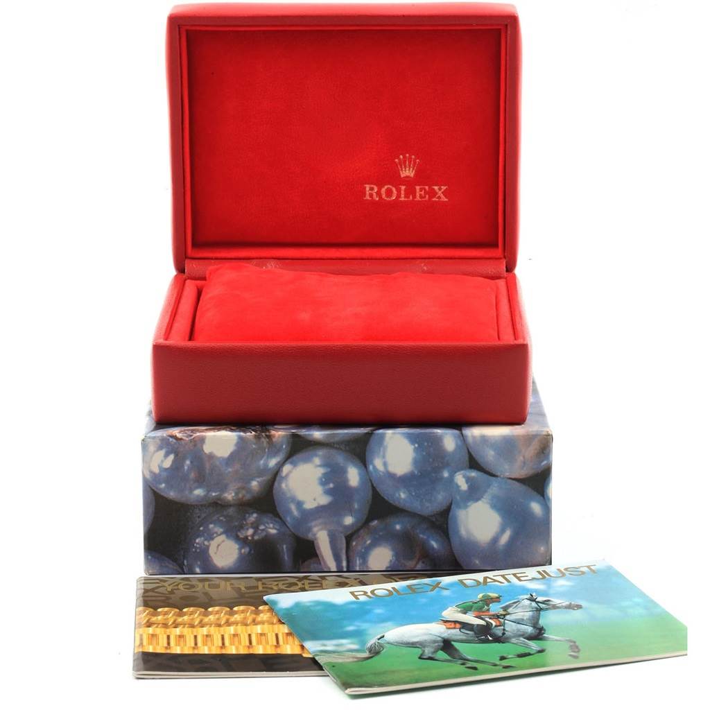 The image shows the opened packaging of a Rolex Datejust 79174 Women
s Stainless Steel Mother of Pearl Dial 79174 Women
s Stainless Steel Mother of Pearl Dial watch, including the red box and user manuals.