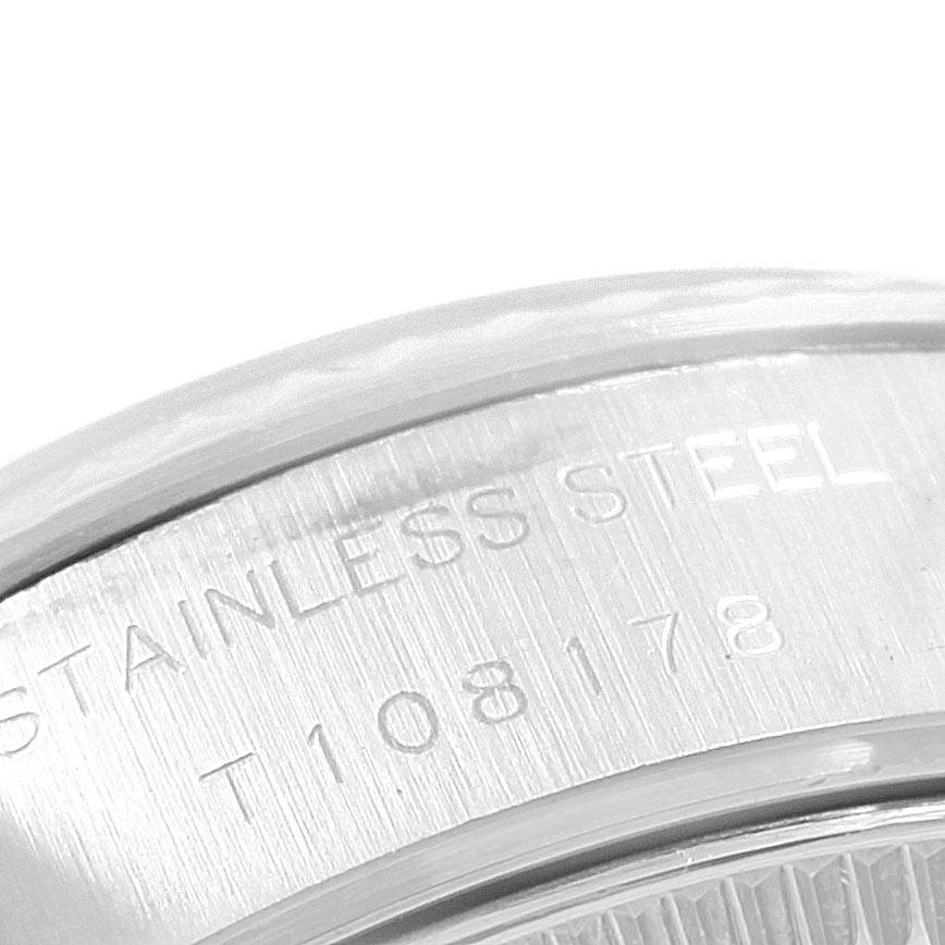 This close-up image shows the inscription "STAINLESS STEEL" and part of the serial number on the case back of a Rolex Datejust 69174 Women's Stainless Steel White Dial 69174 Women's Stainless Steel White Dial model.