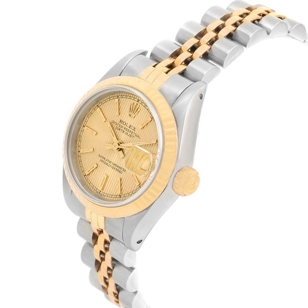 This image shows a Rolex Datejust 69173 Women's Stainless Steel Champagne Dial 69173 Women's Stainless Steel Champagne Dial watch from a three-quarter view, highlighting its gold fluted bezel, champagne dial, and two-tone bracelet.
