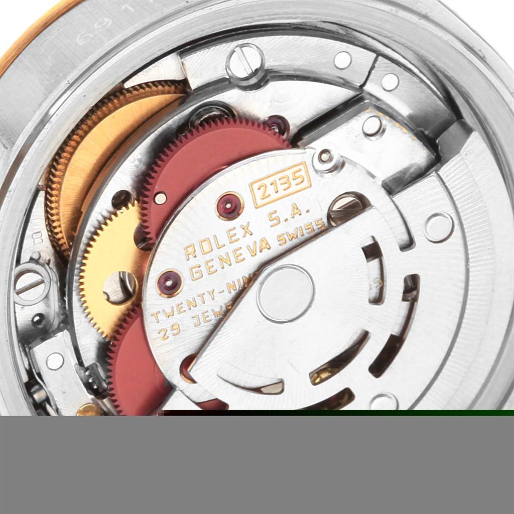 This image shows a close-up of the internal mechanism of a Rolex Datejust 69173 Women's Stainless Steel Champagne Dial 69173 Women's Stainless Steel Champagne Dial watch, highlighting gears and parts of the movement.